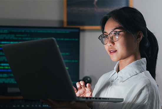 Young professional looking at laptop screen